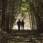 Grant (Gordon Pinsent) and Fiona (Julie Christie) take a walk in the woods in Away From Her